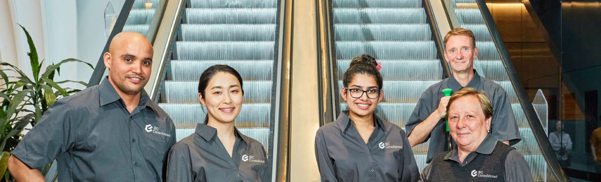 Cleaning staff in front of an escalator